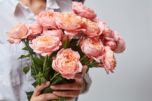 woman holding big fragrant bouquet of pink roses in the hands as a gift. Valentine's Day, Mother's Day