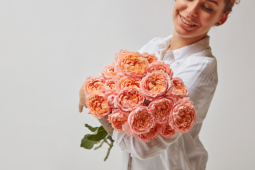 happy smiling girl holding a large bouquet of pink roses. valentine's day, mother's day