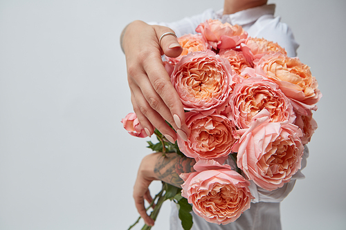 Bouquet of pink media flowers, in the hands of a girl with a tattoo bouquet of roses, mother's day, valentine's day