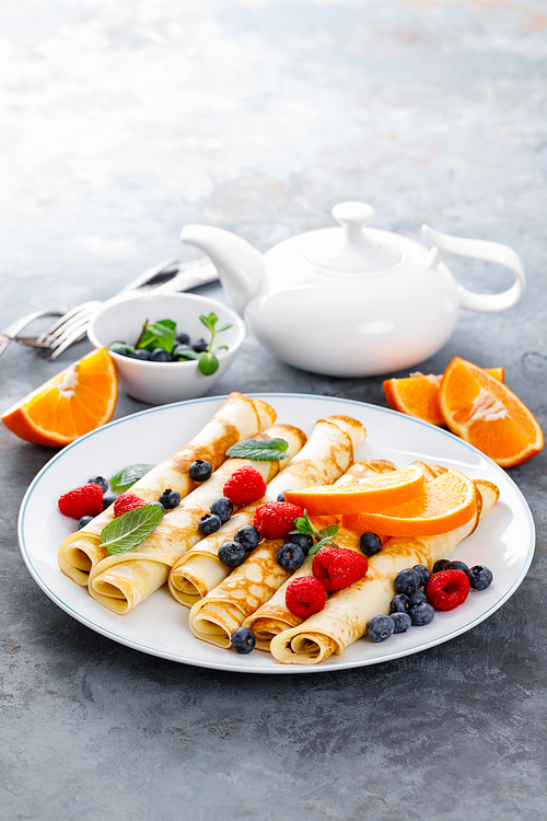 sweet crepes wrapped with fresh berries, crepes with blueberry and raspberry for breakfast