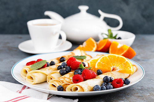 sweet crepe wrapped with fresh berries, crepes with blueberry and raspberry for breakfast