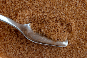 Detail of Browm sugar and spoon from sugar cane - useful as a background.