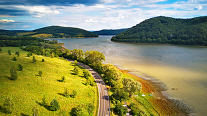 Summer landscape with lake and mountains. Road on the lakeside. Aerial view of Storage reservoir Velka Domasa, river Ondava, Slovakia