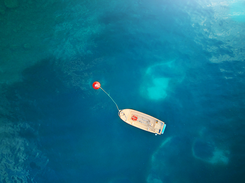 Boat. Aerial view of boat in sea. Beautiful summer seascape with ships, clear azure water at sunny day. Top view.