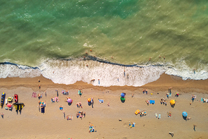 Aerial view at the beach. People relax on the sea shore. Beautiful natural seascape and summer time