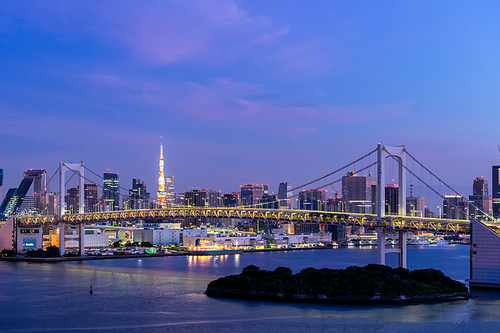aerial view of tokyo skylines with  bridge and tokyo tower over tokyo bay sunrise dawn twilight from odaiba in tokyo city kanto japan.