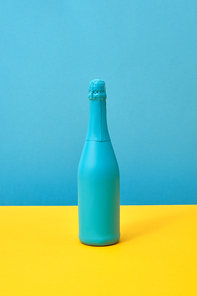 Creative painted spray mock-up blue on a duotone yellow-blue background with copy space. Minimalism concept.