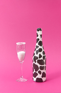 Holiday glass of white powder as a sugar and creative painted bottle with black spots on a hot pink background, copy space. Congratulation card.