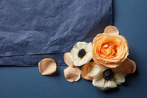 beautiful corner frame of flowers with a black piece of paper on a dark background