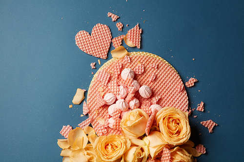 background waffle hearts and rose petals on a dark background