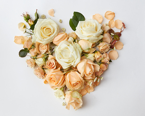 heart of delicate roses on a white background , flat lay