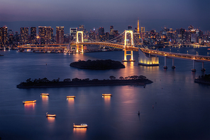 Tokyo skyline with Tokyo Tower and Rainbow Bridge at night in Tokyo, Japan
