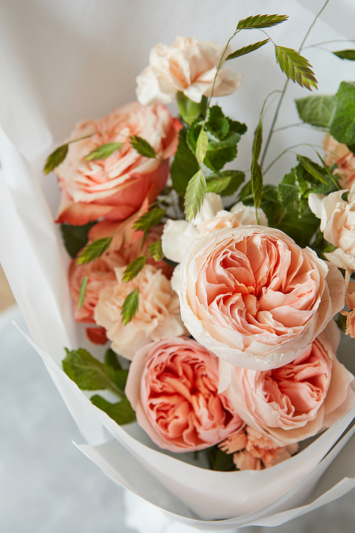 Beautiful bouquet of orange roses on white background. Roses in form of bouquet for giving as gift or present to someone.