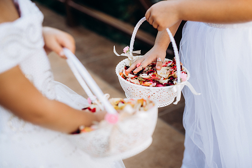 rose petals for the ceremony in wedding baskets in the hands of children