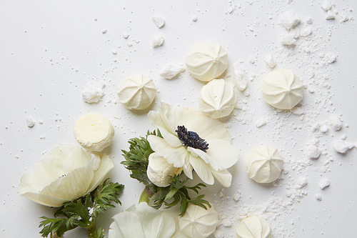 French meringue cookies and flowers on white background ,
