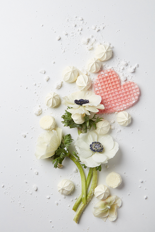 beautiful bouquet of flowers with meringue and waffle heart isolated on white