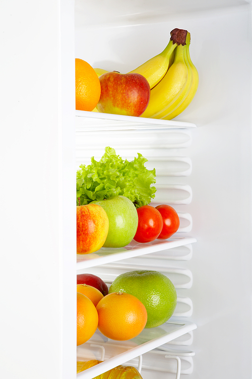 Fresh vegetables and fruit in a white refrigerato