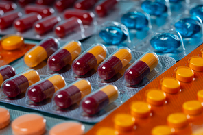 Pile of medical pills and capsules close up macro background. Pills in plastic package. Concept of healthcare and medicine.