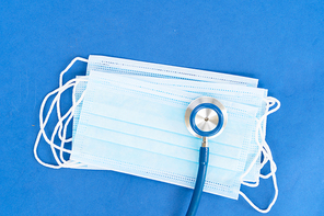 Healthcare concept - stethoscope and white pills on blue , corona viruses concept