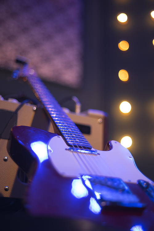 guitar at a concert on stage in the rays of light.