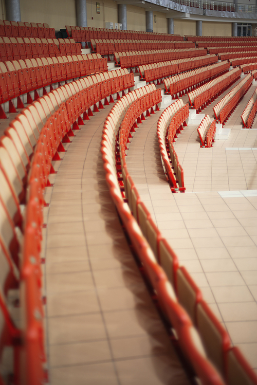 sports tribunes. Empty colored chairs at the stadium