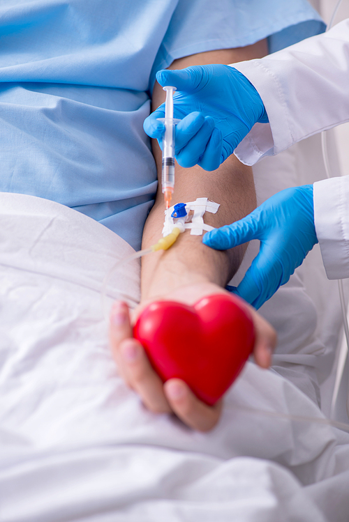 The male patient getting blood transfusion in hospital clinic