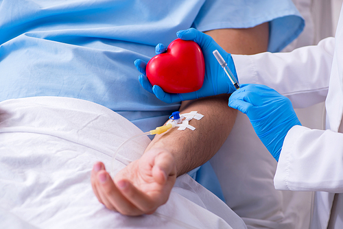 Male patient getting blood transfusion in hospital clinic