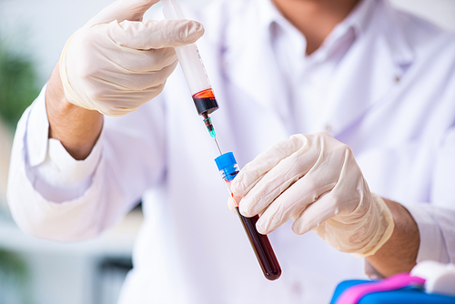 Young lab assistant testing blood samples in hospital