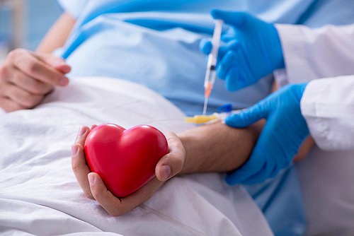 The male patient getting blood transfusion in hospital clinic