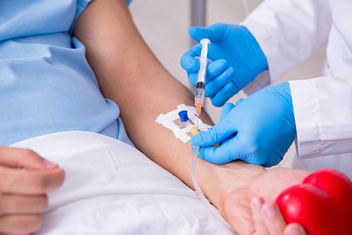 The male patient getting blood transfusion in hospital clinic