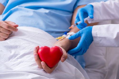 The male patient getting blood transfusion in hospital clinic