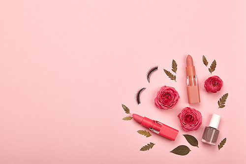 Fashionable Women's Cosmetics and Accessories. Falt Lay. Nail Polish and Lipstick. Beautiful Roses Flower. Make Up Cosmetic items Top View. False eyelashes
