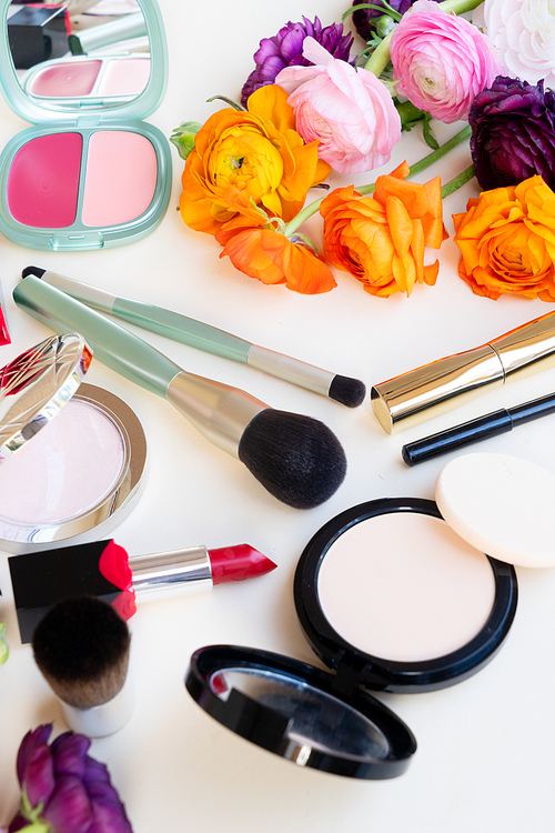 beauty products with make up brushes, top view on pink