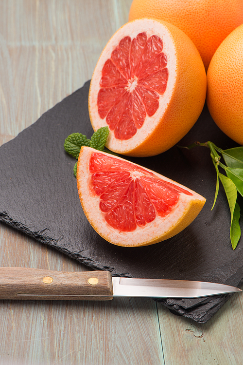 Ripe grapefruit close-up on wooden table background.