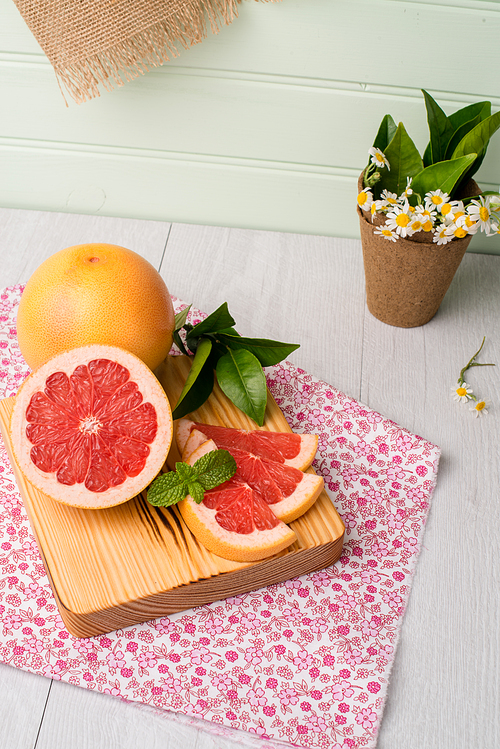 Ripe grapefruit close-up on wooden table background.