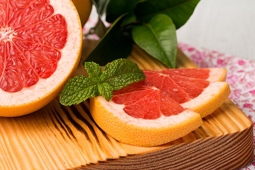 Ripe grapefruit close-up on wooden table background.