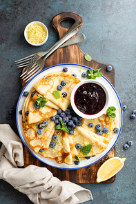 crepes, thin crepe with blueberry jam and fresh berries with lemon zest