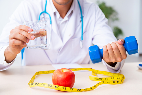 The young male doctor in sport and dieting concept