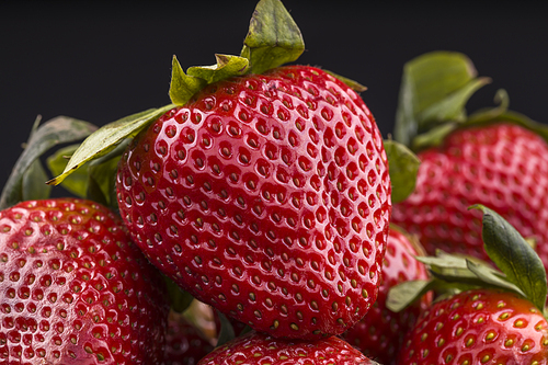 A close up photo of ripe red strawberries.