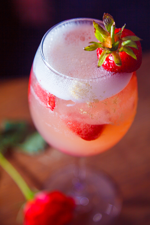 alcohol drink with strawberry on bar. cocktail