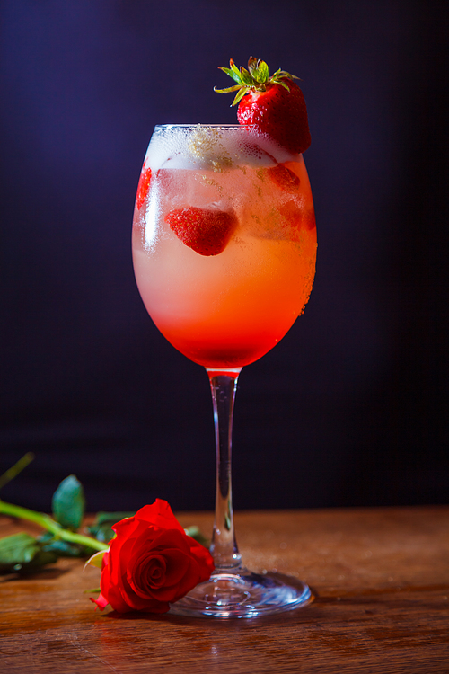 alcohol drink with strawberry on bar. cocktail