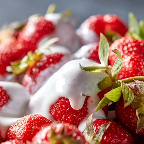 Closeup of vitamin dessert from ripe strawberries with organic cream. Healthy food