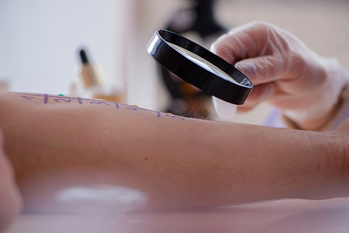 Doctor testing allergy reaction of patient in hospital