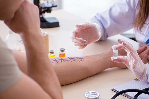 Doctor testing allergy reaction of patient in hospital