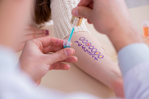 Doctor testing allergy reaction of patient in hospital