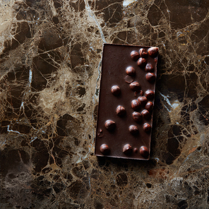 Delicious dark chocolate on a dark marble background