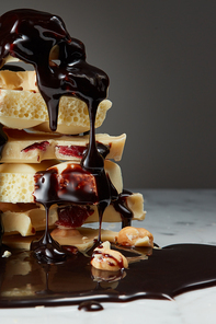 melted chocolate is poured on a stack of slices of white chocolate