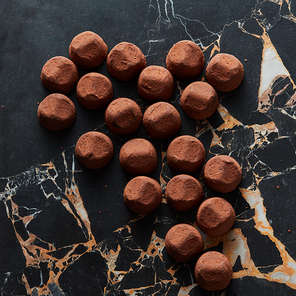 delicious chocolate truffles on a dark marble background