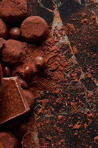 French Chocolate truffles with cocoa powder close-up on dark marble background.