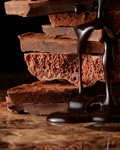 melted chocolate is poured on a stack of slices of dark chocolate
